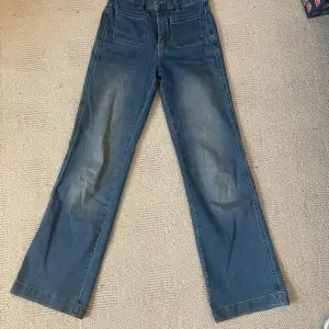 Ett par stretchiga, flared jeans med snygga framfickor. De är mid rise och sitter tajt över låren men löst runt vaderna. De är sparsamt använda utan defekter och säljer för att de är för korta för mig 🫶 