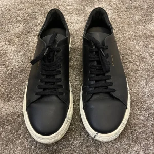 Axel Arigato sneakers - Jättesnygga sneakers från Axel Arigato. Använda två gånger så dem är så gott som nya. Sulan har tiedie mönster och skorna är i svart läder. Köpta för 1700kr 