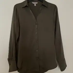 Olivgrön sidenskjorta/blus från H&M. Använd 1 gång. Storlek xs men mer som storlek s.
