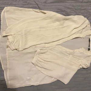 Beige blus - Säljer denna beige fladdriga blus som är ett snäpp genomskinlig. Super snyggt med ett vitt linne under på en varm sommar dag!