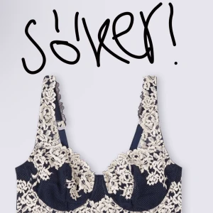 Söker! 75b - Snygg korsett i svart och vit spets med justerbara axelband. Perfekt för en elegant look med vackra spetsdetaljer som ger en lyxig känsla.