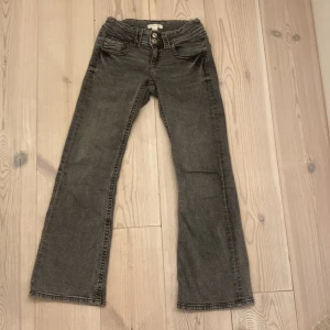 Gråa jeans från Gina tricot! Storlek 152!💕 - Säljer ett par grå jeansbyxor från Ginatricot i storlek 152 som även har en justerbar midja! De har en klassisk femficksdesign med knapp och dragkedja framtill. Dem är bootcut och low waist! Den har ett märke vid kanten(bild 4) men syns knappt på! Köpta för 299!💕