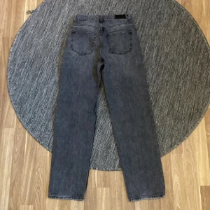 Grå midrise jeans - Säljer ett par snygga grå jeans från Gina i storlek 34. De har en straight passform och är perfekta för både vardag och fest. Jeansen är i bra skick och har en medelhög midja. Använda en gång❤️