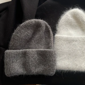 Grå stickad mössa - Mysig grå stickad mössa perfekt för kyliga dagar. Den har en klassisk design med uppvikt kant och är tillverkad i ett mjukt material som håller dig varm.
