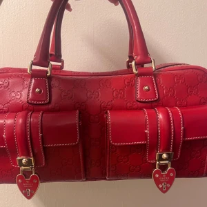 Gucci -  Gucci Handbaa Heart Lock Joy Boston i rött Guccissima-läder och guld-hårdvara. Limited av Gucci Produktens kvalitet är: A vilket betyder att produkten är se nästa ny .Mått: 35*17*12cm.den är äkta har inte kvitto ,hörs av er vid DM Möta upp Stockholm