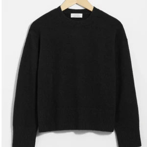 Svart tröja från & Other Stories - Säljer en stilren svart tröja från & Other Stories. Tröjan har en klassisk rund halsringning och långa ärmar. Den är ribbad vid ärmslut och nederkant vilket ger en snygg passform. Perfekt för en minimalistisk look.