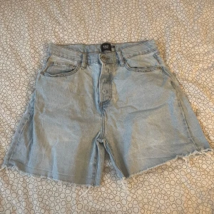 Ljusblå jeansshorts från 157 - Snygga ljusblå jeansshorts från 157 med fransiga kanter och klassisk femficksdesign. Perfekta för en avslappnad stil. De har en knapp och dragkedja framtill. Säljer för dem inte riktigt är min stil. Använt max 5 ggr