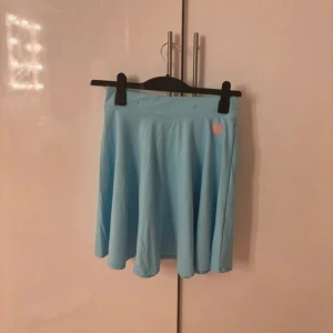 Dolly Style My Team kjol med hängslen - Holly - Detta är en kjol  från Dolly Style som tillhör deras kollektion My Team. Den har en matchande topp och shorts som säljs på min profil. Den är aldrig använd och säljs inte längre på deras hemsida. Den är i storlek M.