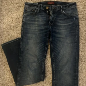  Jack & Jones Jeans  - Säljer ett par snygga mörkblå jeans från Jack & Jones i modellen Regular/Clark. Perfekt inför vintern! Den är i storlek 29/30 (passar mer som 30/32). MÅTT: Midjemått 39 cm (platt)| Ytterbenslängd: 104-106 cm| Fotvidd: 18-19 cm. Skriv privat om du har några funderingar eller vill se fler bilder.