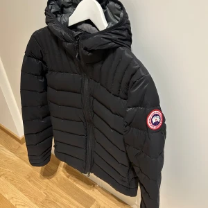 Canada Goose Brookvale / Svart - Modell: Canada Goose Brookvale Size: XS Cond: 8/10 använd fåtal gånger pga ett litet hål vid nedre delen av jackan därav priset.  Nypris 6669 kr