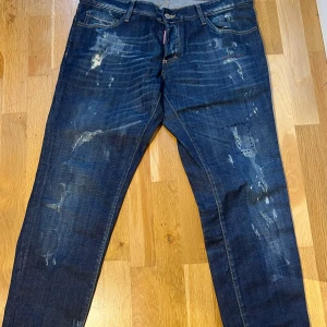 Dsquared2 Mörkblåa Jeans  - Dsquared2 Mörkblåa jeans i storlek 52. Knappt använda och i väldigt bra skick. De har blivit skräddade längst ner och har en benlängd på 72 cm innerlängd. 