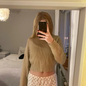 Beige stickad tröja - Säljer en beige stickad tröja med croppad design. Tröjan har långa ärmar och ribbade muddar vid ärmslutet och längst nere samt vid kragen. Super mysig men kommer tyvärr inte till andvändning längre. Säljer lika dan i blå, en för 60kr två för 110kr💗