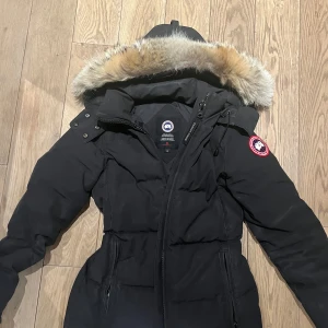 Canada Goose jacka - Canada Goose jacka äkta päls. Säljer då den tyvärr är för liten. Perfekta vinterjackan och så snygg. Storlek S kan passa mindre M. Black- noir, man kan anpassa jackan och göra den mer figursydd samt skjustera luvan och pälsen. Några defekter som syns på bilderna tex lite smutig men har ej tvättat så rekommenderar/ kemtvätt om man verkligen vill ha den ny men det är inget jag lägger märke till vid användning samma med lite små "repor" syns på bilderna. Model 3804L tror den heter Chelsea Parka💕