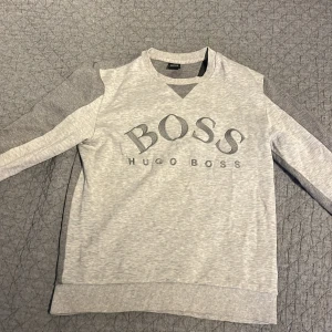 Hugo boss hoodie grå - Extremt snygg Hugo boss hoodie/sweatshirt i grå. Extremt sällsynt då den inte säljs längre! Väldigt bra skick!
