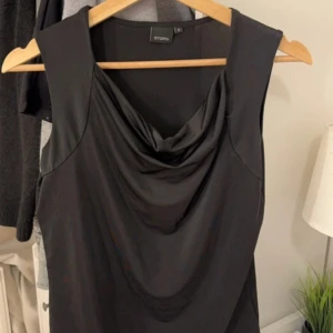 Svart ärmlös topp från Story - Snygg svart ärmlös topp från Story. Den är i ett mjukt och bekvämt material och sitter väldigt elegant