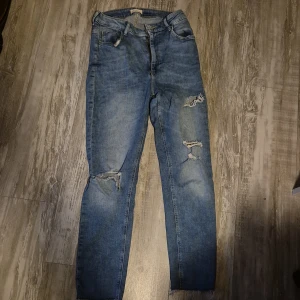 Jeans - Blåa jeans med hål på knäna och låren