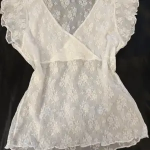 Coquette Y2K white lace blouse with slits on the arms   Stretchy lace  Lined at the bust transparent all over  Will fit large cuz it’s stretchy