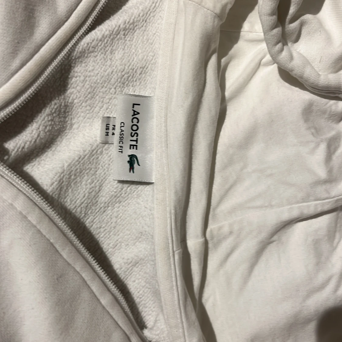 Vit hoodie från Lacoste - 91