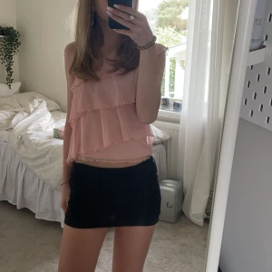 Rosa volanglinne - Säljer ett sött rosa linne med volanger och oneshoulder-design. Perfekt för sommarens varma dagar. Passar bra till både kjol och byxor. Litet litet hål vid sidan men man ser knappt det.