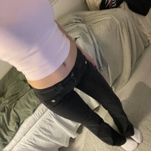 Svarta jeans med bootcut - Snygga svarta jeans med låg midja och bootcut-stil. De är i jätte fint skick och har snygga detaljer, som fickorna framtill. Dessa går inte att köpa i butik längre!! 🎀💕