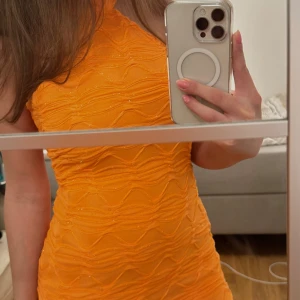 Orange glittrig klänning - Superfin o färgstark orange halterneck klänning, även glittrig!! Den är figurnära o sitter så fint på🧡🧡  Använd 1 gång☺️  Strl xs