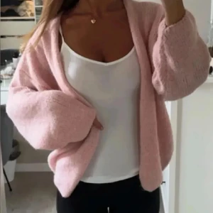 Rosa stickad kofta - Mysig rosa stickad kofta med en avslappnad passform. Perfekt för kyliga dagar och att mysa i hemma. Koftan har långa ärmar och en öppen design utan knappar💕