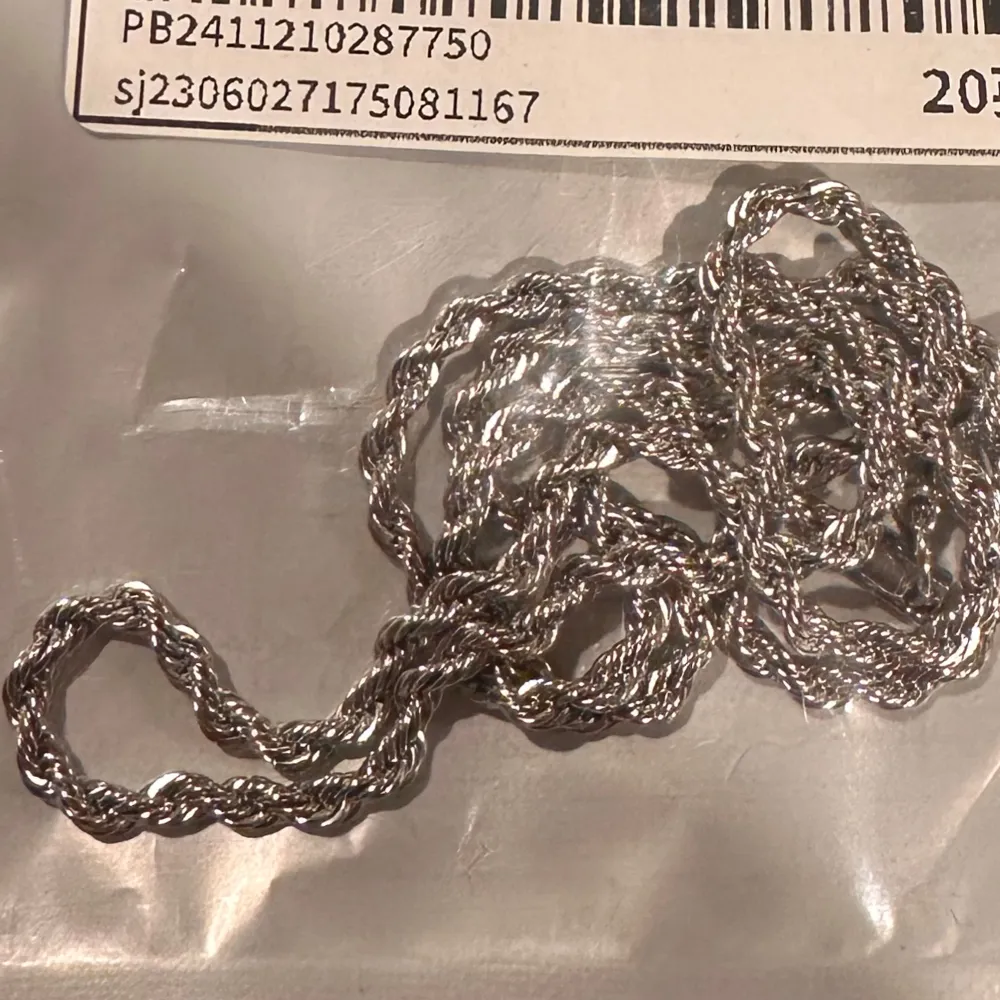 Elegant silverfärgat armband med tvinnad design. Perfekt för att ge en stilren touch till din outfit. Armbandet har en säker låsning och passar de flesta handleder.. Asusteet.