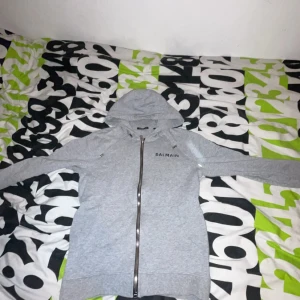 Balmain hoodie  - Säljer en äkta balmain tröja i 8/10 skick för ett bra pris. Funkar perfekt nu till hösten då den är varm. Tröjan är köpt för 2-3 år sen men knappast använd vid frågor eller funderingar hör av er vid snabb affär sänks priset. Fraktar och möts upp!🚚🤩