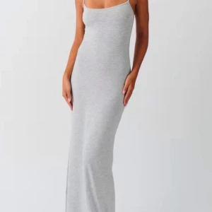Grå långklänning - Snygg och stilren grå långklänning med smala axelband. Perfekt för en minimalistisk look. Klänningen har en figurnära passform som framhäver silhuetten. Storlek XL