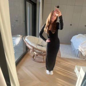 Skims långklänning - Skims svart långklänning med långärmad design och en u-ringad hals. Original pris 1230kr, aldrig använd och fick i present förra julafton🙌