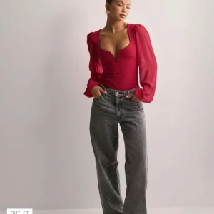 Röd body med långa ärmar - Snygg röd body med djup v-ringning och långa puffärmar. Perfekt för allt💞köpt från Nelly men helt oanvänd, bilderna är lånade💞skriv om ni har några frågor eller funderingar och om ni vill ha fler bilder💞Använd gärna köp nu!💞