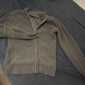 Grå ribbad kofta med dragkedja - Säljer en stilren grå ribbad kofta med dragkedja. Perfekt för kyligare dagar och lätt att matcha med andra plagg. Koftan har långa ärmar och en bekväm passform. Säljer pga att plagget är för stor. Skriv vid fundering 🤔 