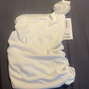 Topp - Så söt topp från newtonmetrar med en fin liten ros , den är oanvänd med prislapp på och säljs för 70 kronor