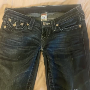 Mörkblå jeans från True Religion - Jag säljer ett par snygga mörkblå jeans från True Religion. Jag har sytt de bootcut,De har vita sömmar vid fickorna och är storlek 26, jag skulle säga att de passar någon som är 155-160. Skriv för fler bilder! + jag står inte för frakt! 