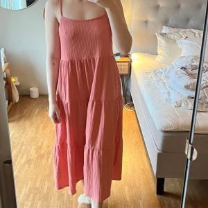 Rosa klänning från Zara - Säljer en superfin rosa klänning från Zara i storlek M. Den har smala axelband och en luftig passform, perfekt för sommardagar. Materialet är mjukt och bekvämt, vilket gör den idealisk för både vardag och fest. Klänningen är i mycket bra skick och redo för nya äventyr! 🌸