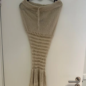 Strandkjol - En virkad strandkjol i en brun färg 