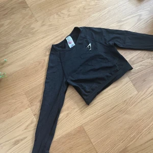Gymshark träningströja - Svart träningstopp från gymshark. Använd men i fint skick