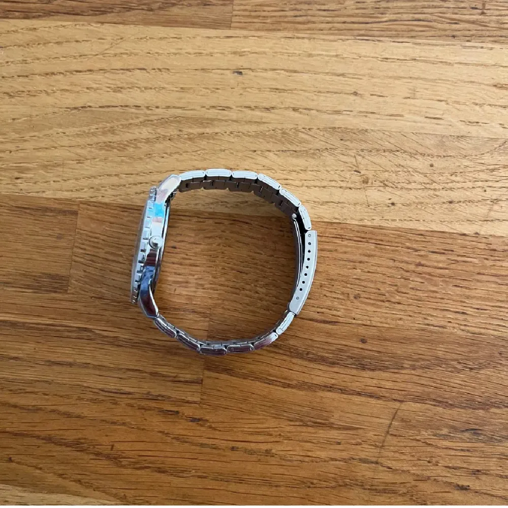 Säljer en snygg och stilren silverfärgad klocka från Regal. Den har en robust metallarmband och en detaljerad urtavla med flera små urtavlor för extra funktioner. Perfekt för både vardag och fest!. Accessoarer.