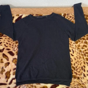 Svart tröja från The Black Label Collection - Säljer en stilren svart tröja från The Black Label Collection. Den är långärmad och perfekt för både vardag och fest. Materialet känns mjukt och bekvämt, vilket gör den idealisk för höst och vinter. Passar bra till jeans eller kjol för en avslappnad look.