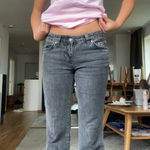 Grå jeansbyxor - Säljer ett par grå jeansbyxor i nyskick. De är högmidjade och har en straight passform. Byxorna har klassiska fem fickor och stängs med dragkedja och knapp. Perfekta för både vardag och fest!