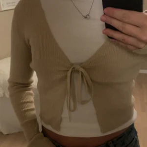 Stickad kofta  - Säljer denna jättesöta kofta från NAKD, den är använd få tillfällen och som ny🤎storlek M men skulle säga att den passar zs-M