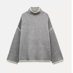 Grå polotröja med kontrastsömmar -  Säljer en snygg grå polotröja med vita kontrastsömmar. Tröjan har en lös passform och långa ärmar, ett måste i garderoben!