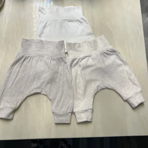 Mjukisbyxor för baby från H&M, strl 50 - Tre par mjuka och sköna babybyxor från H&M i storlek 50.Tillverkade i ekologisk bomull.