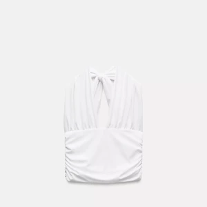 Vit omlott halterneck topp - Snygg vit halterneck topp med omlott-detalj och knyt i nacken. Toppen har djup v-ringning och rynkade sidor för en cool och trendig look och även öppen i ryggen. 💕