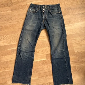 Blå jeans från Gas, rak modell - Snygga blå jeans från Gas i rak modell med klassisk design och knäppning med knappar. Jeansen har slitna detaljer och ljusare partier framtill och baktill. 