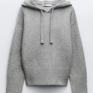 Grå hoodie från Zara med huva - Säljer en stilren grå hoodie från Zara med mjukt stickat material och ribbade muddar. Tröjan har huva med snörning och långa ärmar, perfekt för chill dagar. Enkel design som funkar till jeans eller mjukisbyxor.