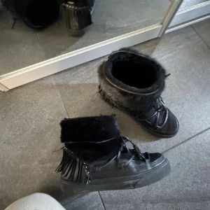 Svarta Inuikii boots med päls och fransar - intressekoll på mina älskade inuikiis😇 använda med kärlek, så bra skick! Nypris/köpta för runt 5000  -lämna gärna prisförslag och hör av er om frågor💋äkta päls, läder och mocka! 