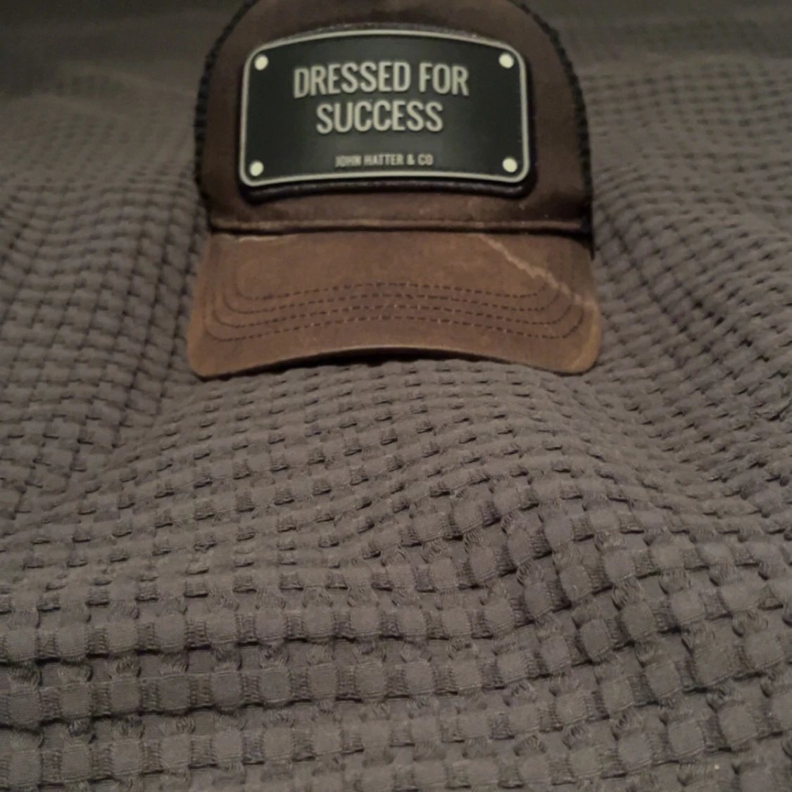 Svart/brun keps John Hatter & Co