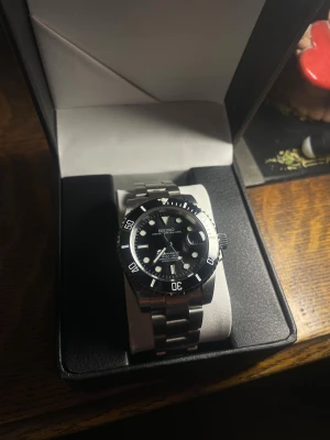 Seiko ”Submariner” Mod - Helt nybyggd Seiko ”Submariner” Mod  Specifikationer: Storlek: 40mm Urverk: Nh35 (Automatiskt) Material: 904L Rostfritt Stål Glas: Sapphire Glas Tavla: Svart  Armband: Viklås och Justerbart  Krona: Screw Down Vattentålighet: 30 Meter Klocklåda ingår
