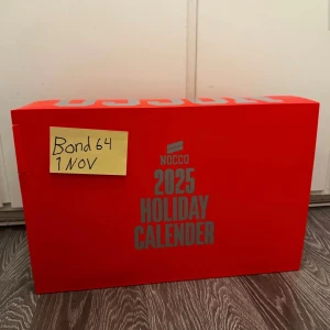 NOCCO 2025 Holiday Calender - NOCCO 2025 Holiday Calender i nyskick. Oöppnad förpackning med 24 luckor, perfekt som adventskalender. Innehåller olika NOCCO-drycker, detaljerad näringsinformation på baksidan. Snygg röd design, inga synliga skador eller slitage. Köpt av en på tradera och har ingen nytta av den längre så säljer vidare den så snabbt som möjligt.